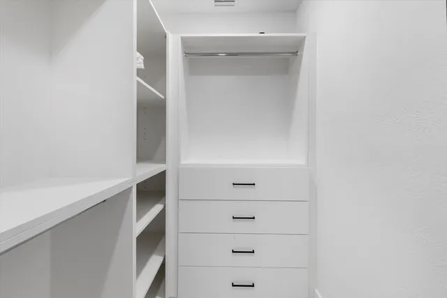a view of an empty walk in closet