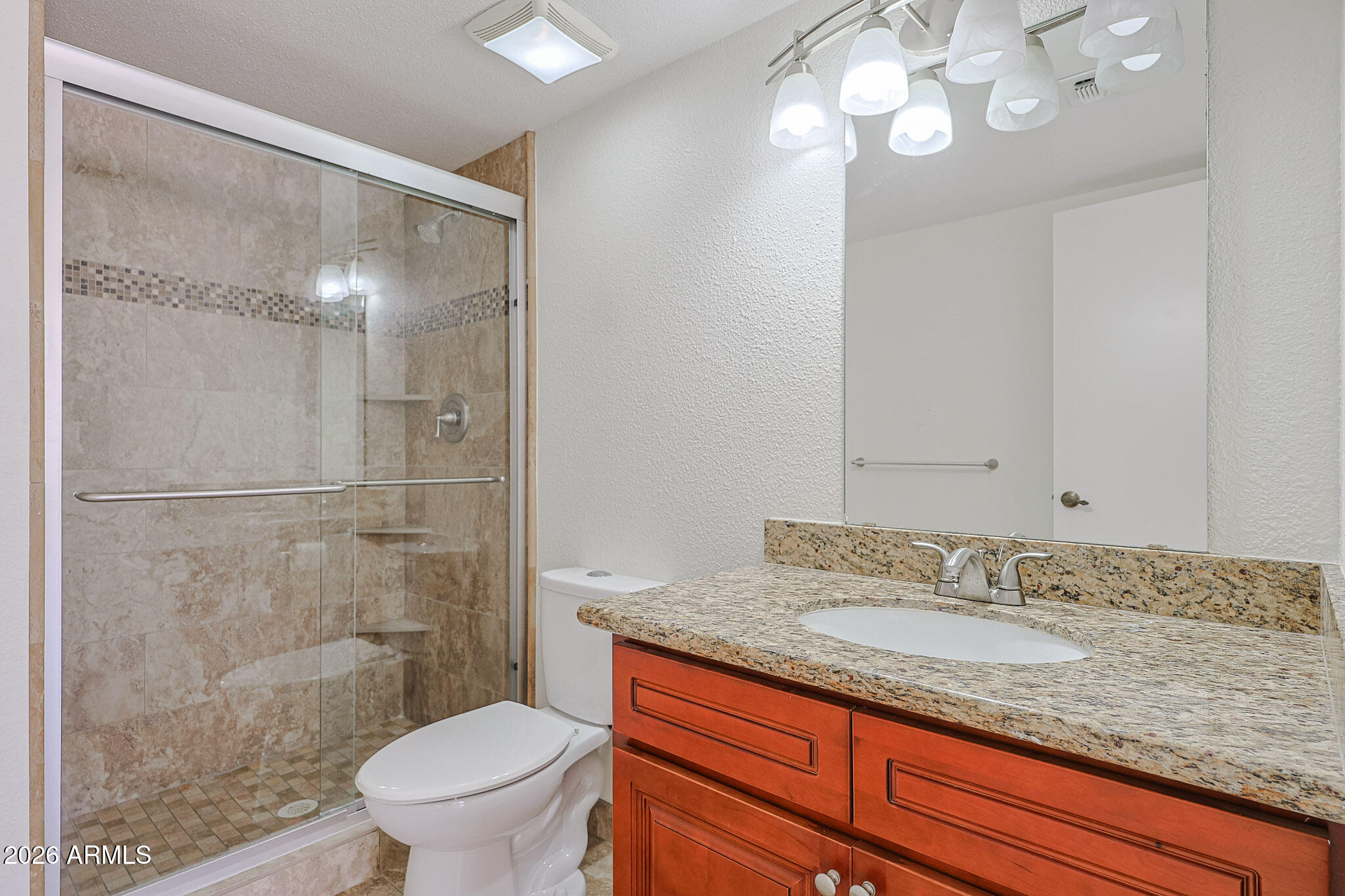 7920 East Camelback Road, Unit 111 Scottsdale, AZ 85251 - Photo 14 of 32 a bathroom with a granite countertop sink a toilet a mirror and shower