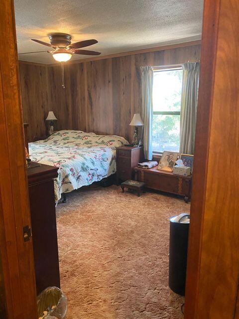 25650 Kaiser Road Desert Center, CA 92239 - Photo 17 of 44 a bedroom with a bed and a chandelier