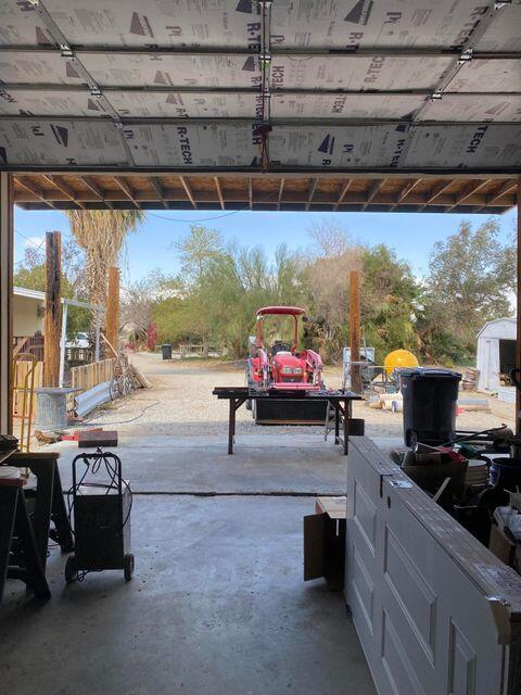 25650 Kaiser Road Desert Center, CA 92239 - Photo 5 of 44 a living room with furniture a flat screen tv and a floor to ceiling window