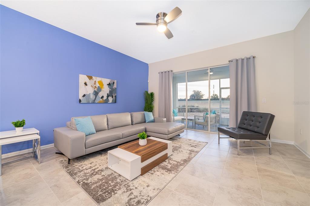 817 Ocean Course Avenue Davenport, FL 33896 - Photo 12 of 32 a living room with furniture and a large window