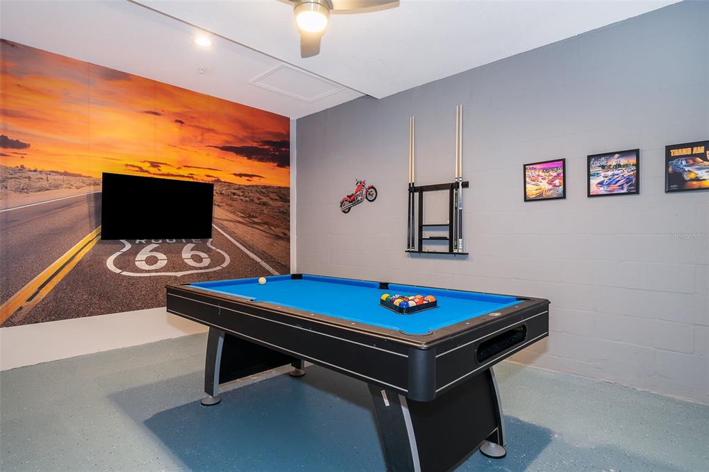 817 Ocean Course Avenue Davenport, FL 33896 - Photo 14 of 32 a room with furniture pool table and a flat screen tv