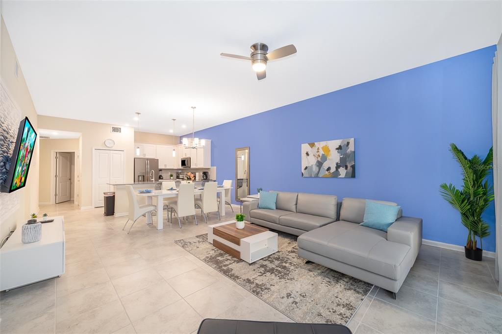 817 Ocean Course Avenue Davenport, FL 33896 - Photo 3 of 32 a living room with furniture and a flat screen tv