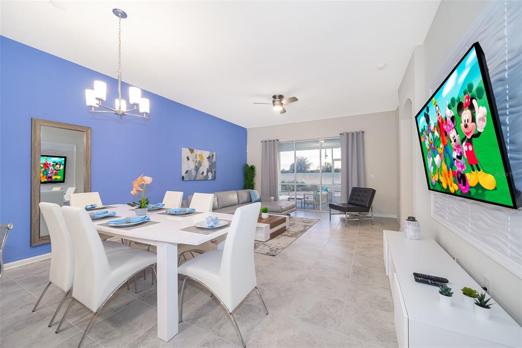 817 Ocean Course Avenue Davenport, FL 33896 - Photo 8 of 32 a view of a dining room with furniture a rug and wooden floor
