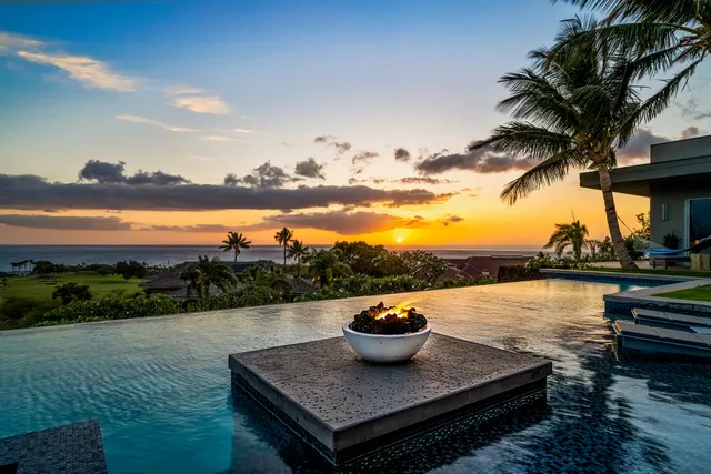 a large kitchen with a large counter top appliances and wooden floor