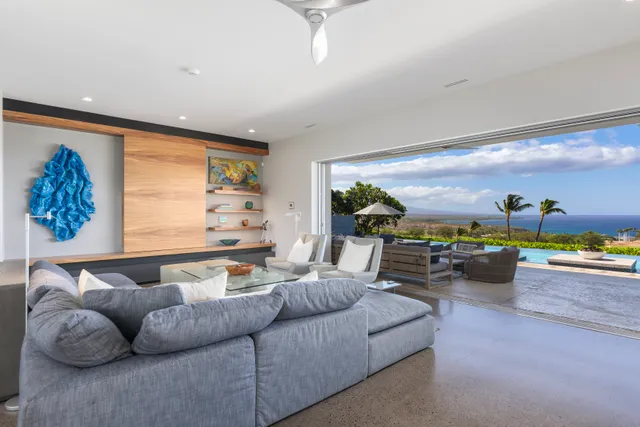 an outdoor sitting area with furniture and city view