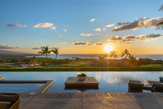 a bedroom with a bed mirror and couch