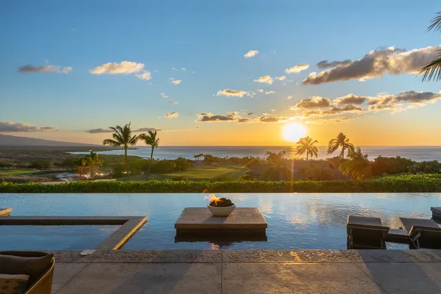a bedroom with a bed mirror and couch