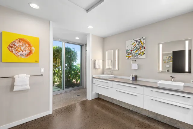 a living room with patio furniture and a potted plants