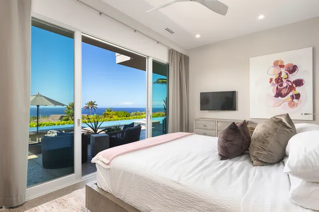 a view of a patio with couches chairs under an umbrella