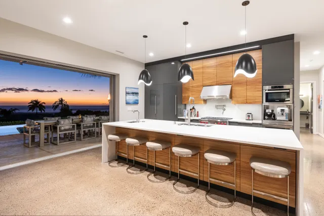 a large kitchen with a table and chairs