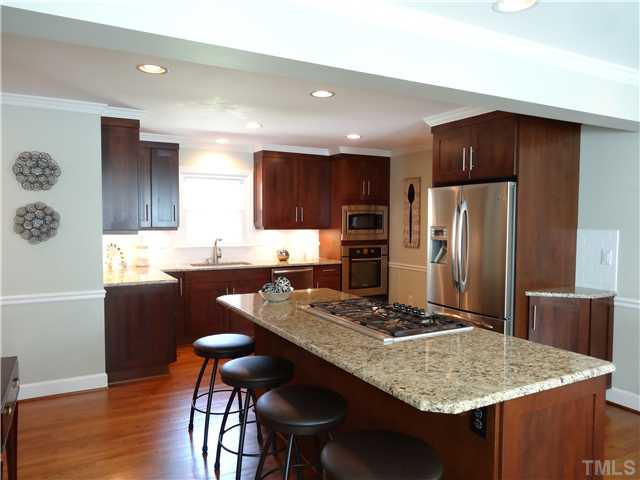 413 Kenwood Court Raleigh, NC 27609 - Photo 8 of 19 Gas stove top set on a beautiful island has bar space to entertain and host! Kitchen