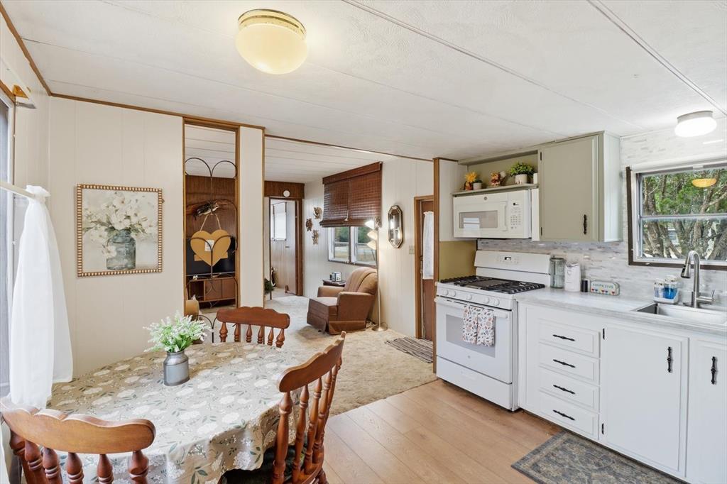 7749 West Chassahowitzka Street Homosassa, FL 34446 - Photo 11 of 30 a kitchen with granite countertop a sink cabinets and wooden floor