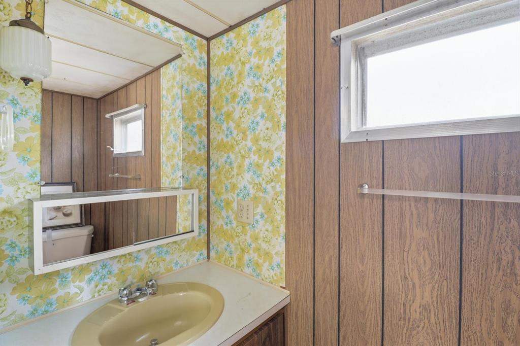 7749 West Chassahowitzka Street Homosassa, FL 34446 - Photo 17 of 30 a bathroom with a sink a mirror and a shower