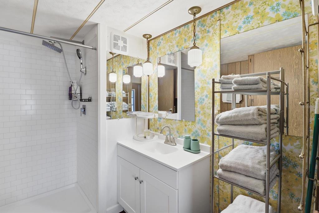 7749 West Chassahowitzka Street Homosassa, FL 34446 - Photo 21 of 30 a bathroom with a sink vanity mirror and shower