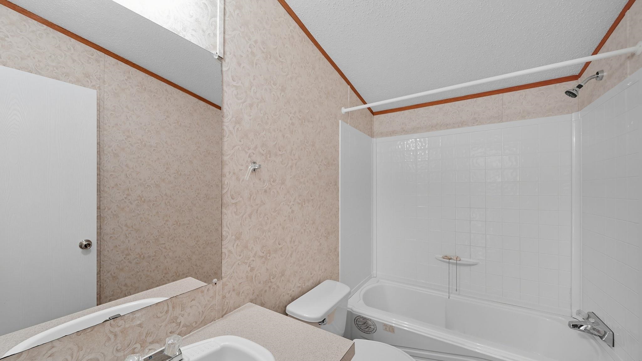 835 Robertson Road Mason, TN 38049 - Photo 12 of 22 a bathroom with a bathtub and a shower