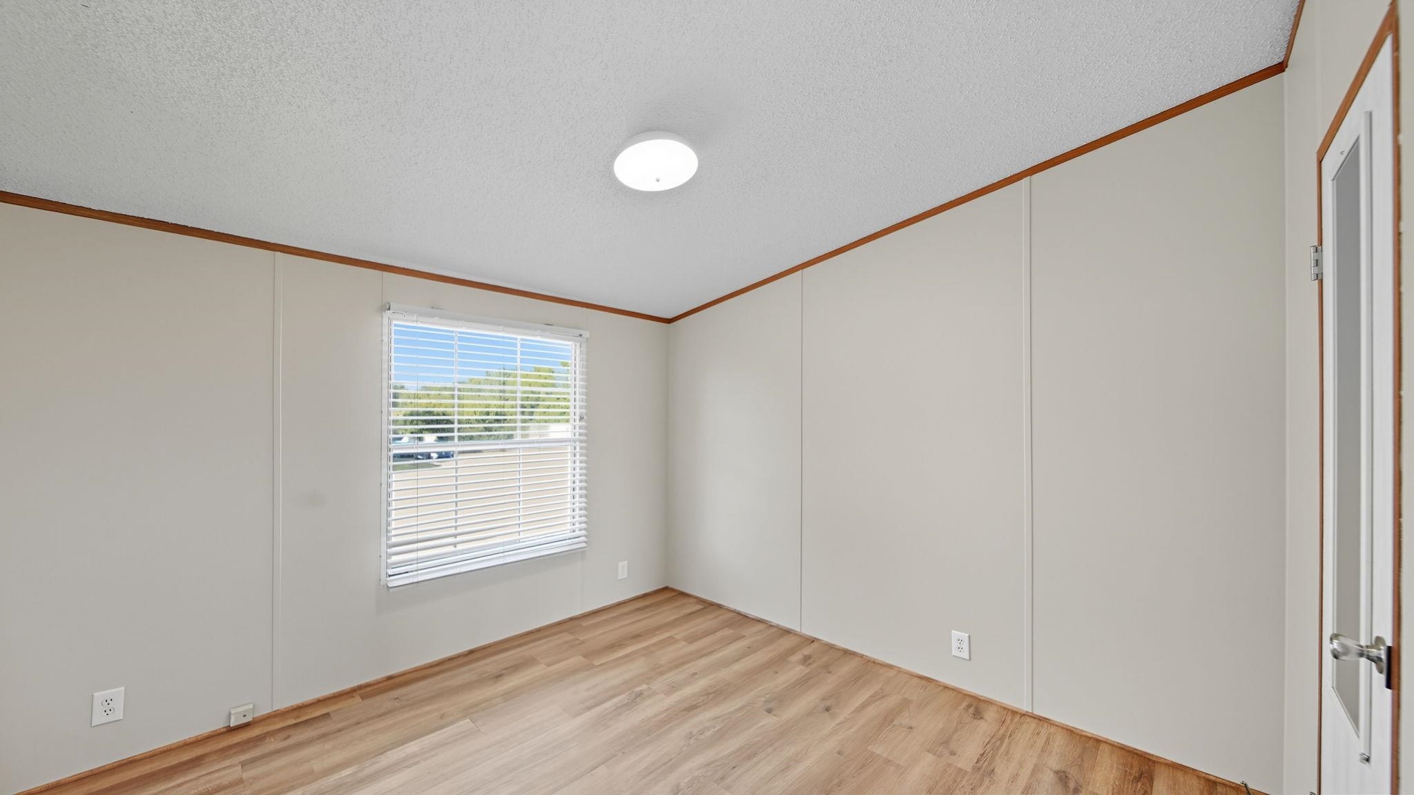 835 Robertson Road Mason, TN 38049 - Photo 15 of 22 a view of an empty room with wooden floor and a window