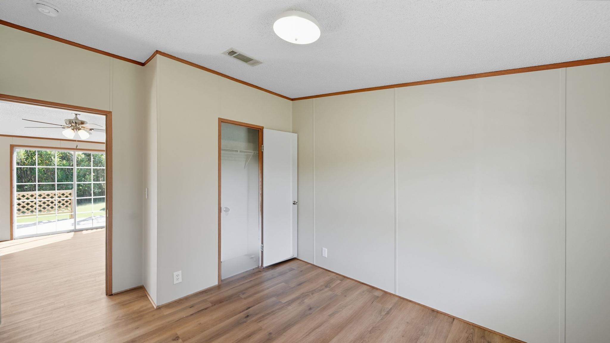 835 Robertson Road Mason, TN 38049 - Photo 18 of 22 a view of an empty room with wooden floor and a window