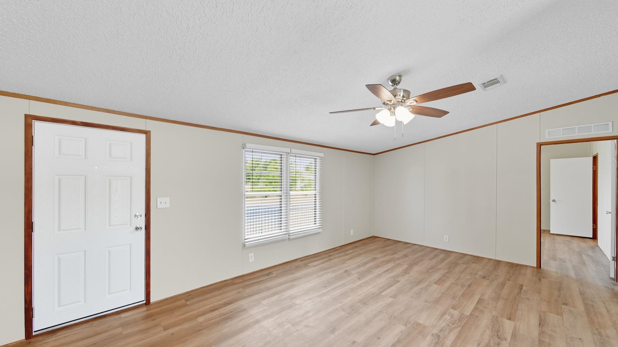 835 Robertson Road Mason, TN 38049 - Photo 2 of 22 wooden floor in an empty room with a window