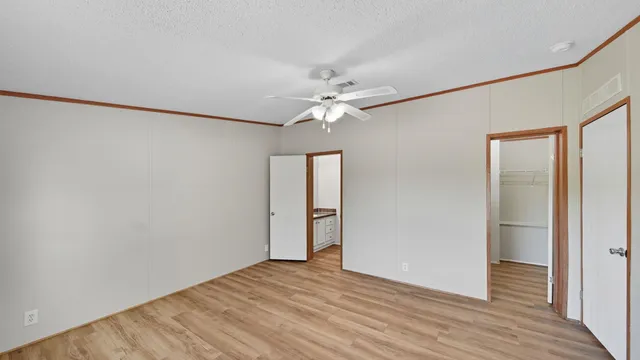 a view of an empty room with wooden floor