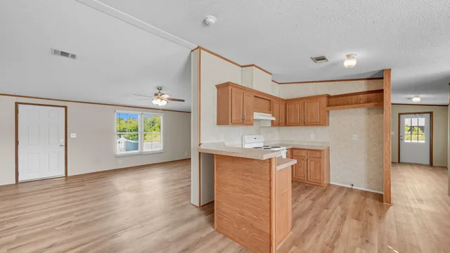 a view of a kitchen cabinets and wooden floor
