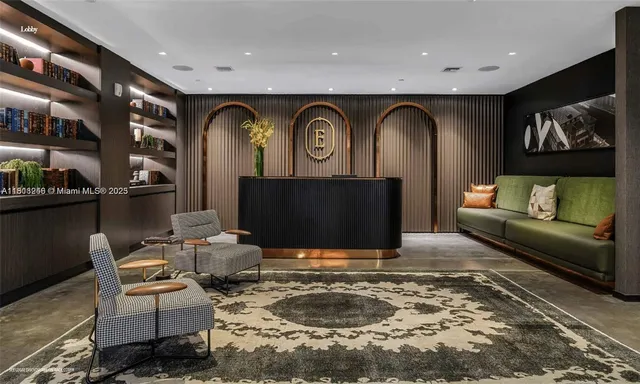 a living room with fireplace furniture and a rug