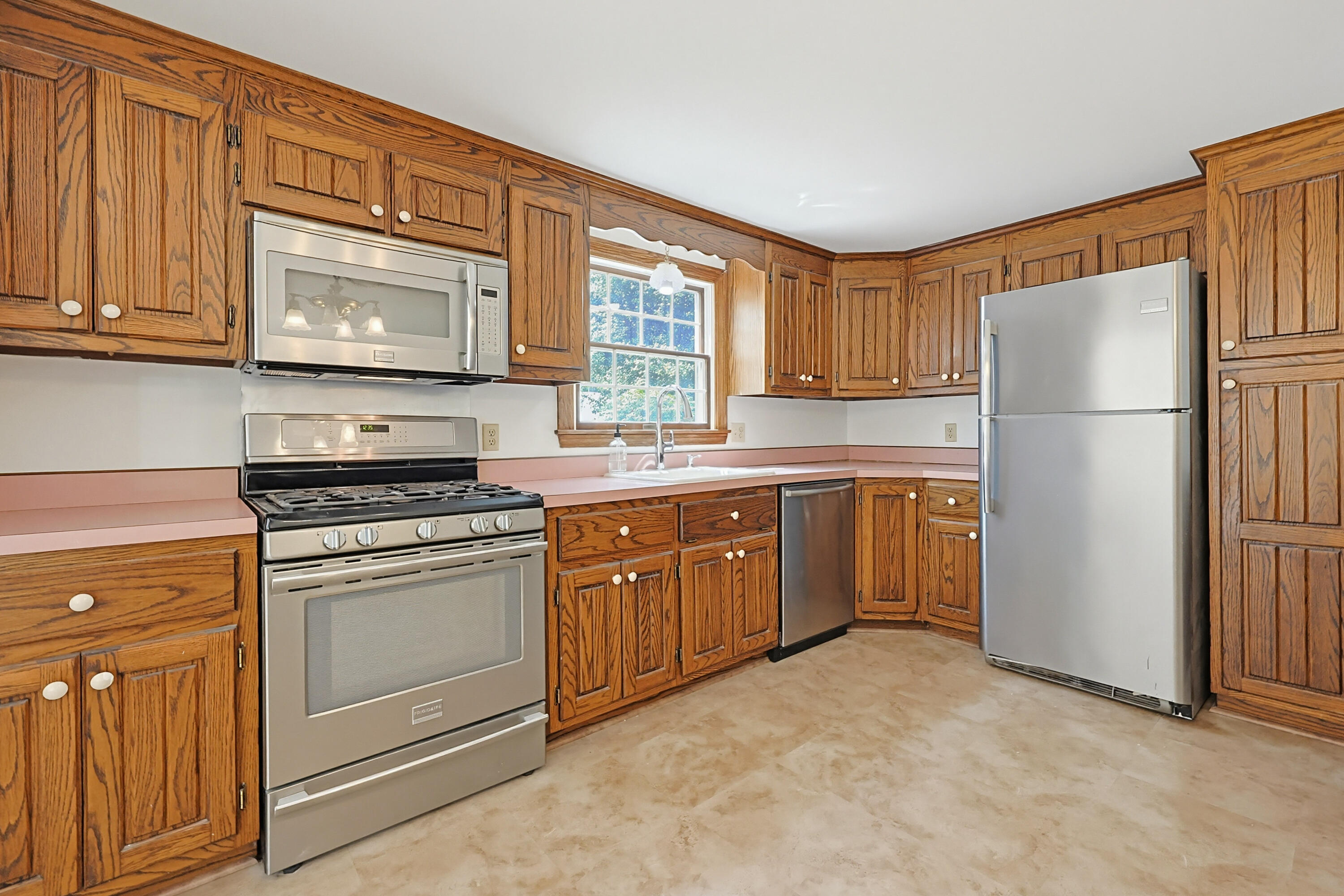 556 Cotuit Road Mashpee, MA 02649 - Photo 15 of 45 a kitchen with a refrigerator sink and microwave