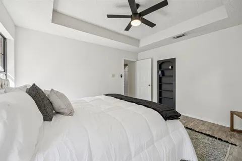 a bedroom with a bed and a ceiling fan
