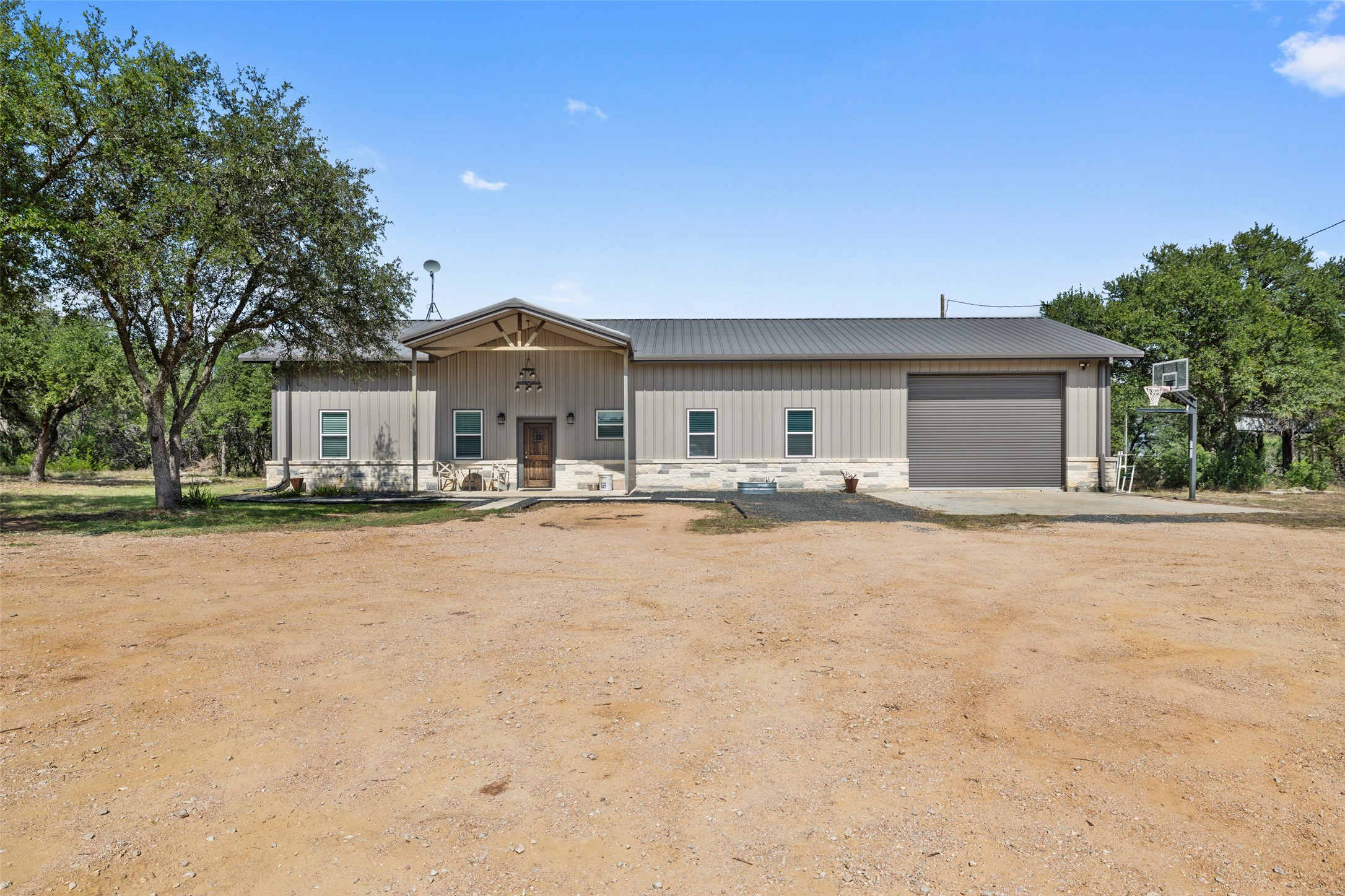 764 Stubbs Road Johnson City, TX 78636 - Photo 14 of 29 A spacious home with a covered porch entry and a convenient roll-up garage door.