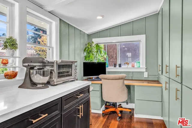 a room with furniture a window and potted plants