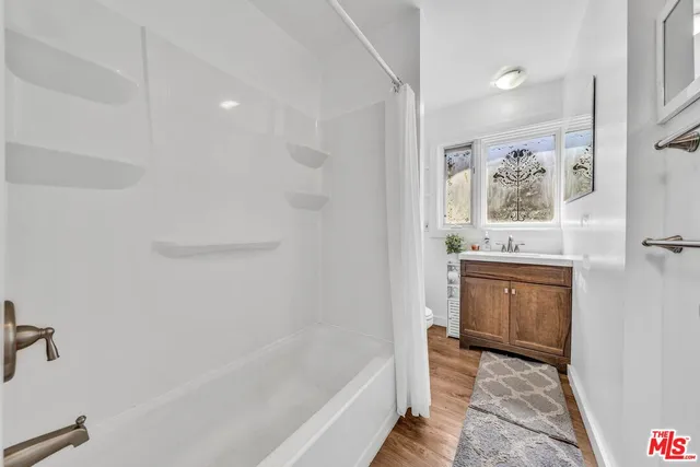 a bathroom with a bathtub and a shower