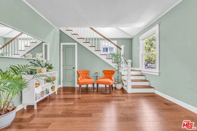 a view of entryway and hall with wooden floor