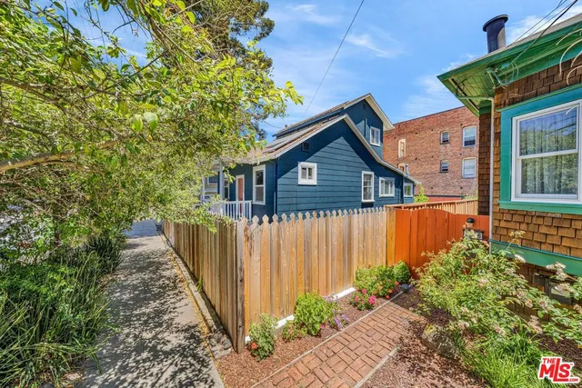 a view of a house with wooden fence