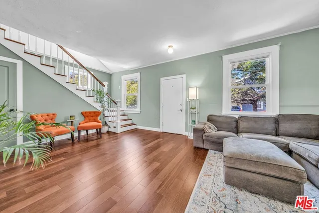 a living room with furniture and wooden floor