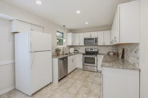 a kitchen with a sink and cabinets