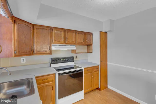 a kitchen that has a sink and a stove