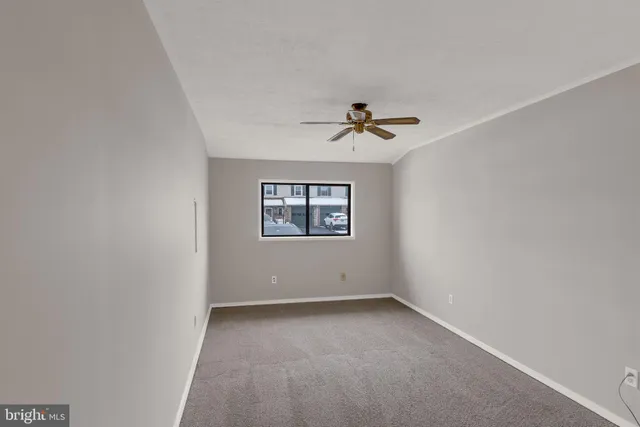 a view of room with a ceiling fan and window
