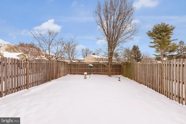 a view of a backyard with snow on the road
