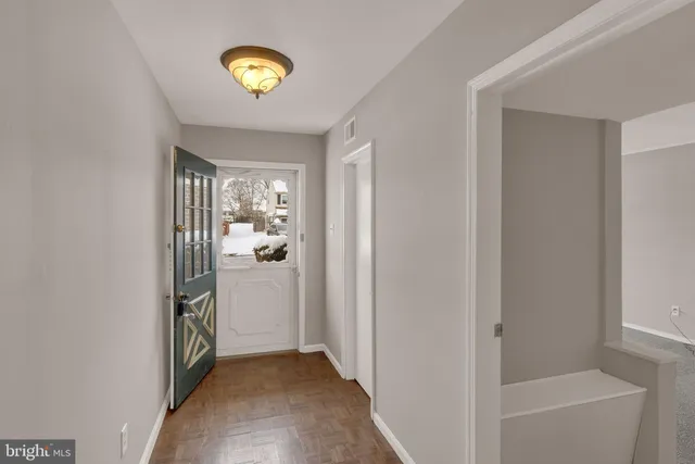 a view of an entryway with wooden floor and windows