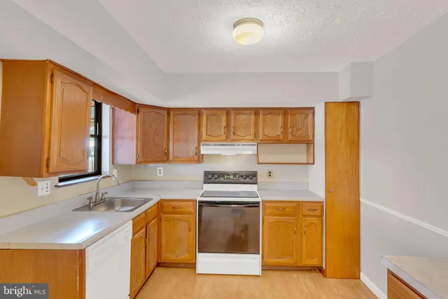 a kitchen with a sink and a stove top oven