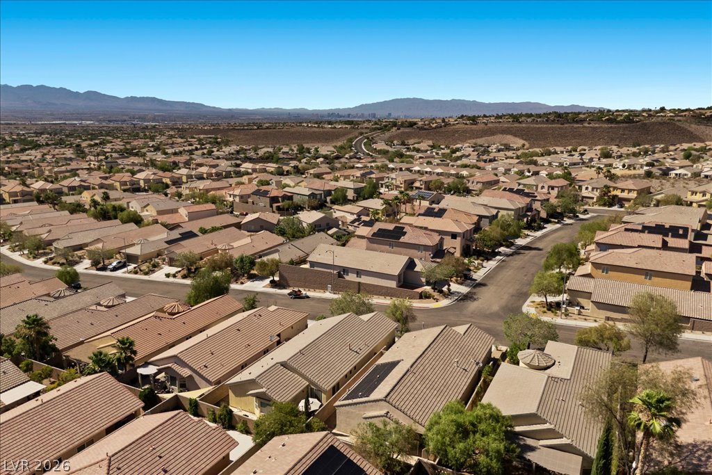 2627 Dirleton Place Henderson, NV 89044 - Photo 38 of 42 Aerial view captures a sprawling residential community nestled against a distant mountain range.