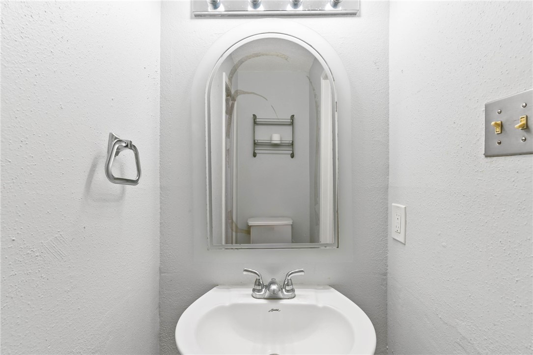 6702 Everhart Road, Unit H102 Corpus Christi, TX 78413 - Photo 7 of 15 a bathroom with a sink and mirror