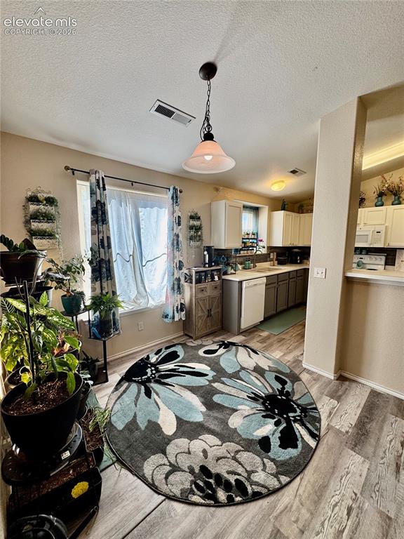3748 Riviera Grove, Unit 203 Colorado Springs, CO 80922 - Photo 10 of 23 a room with wooden floors and stainless steel appliances