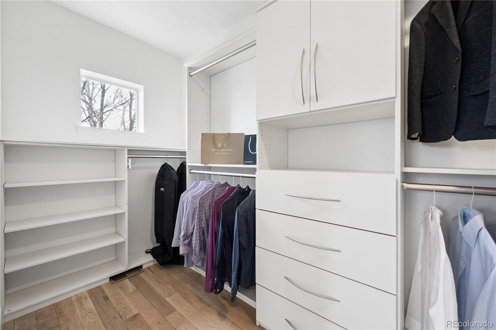 3118 Newton Street Denver, CO 80211 - Photo 11 of 29 a view of walk in closet with clothes and shoes