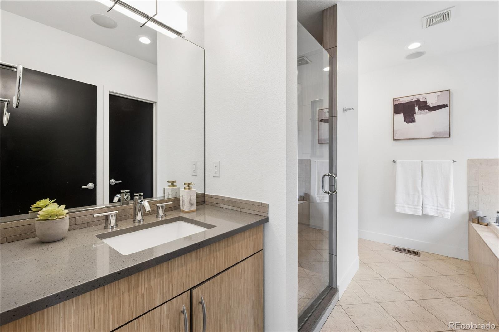 3118 Newton Street Denver, CO 80211 - Photo 12 of 29 a bathroom with a double vanity sink mirror and double
