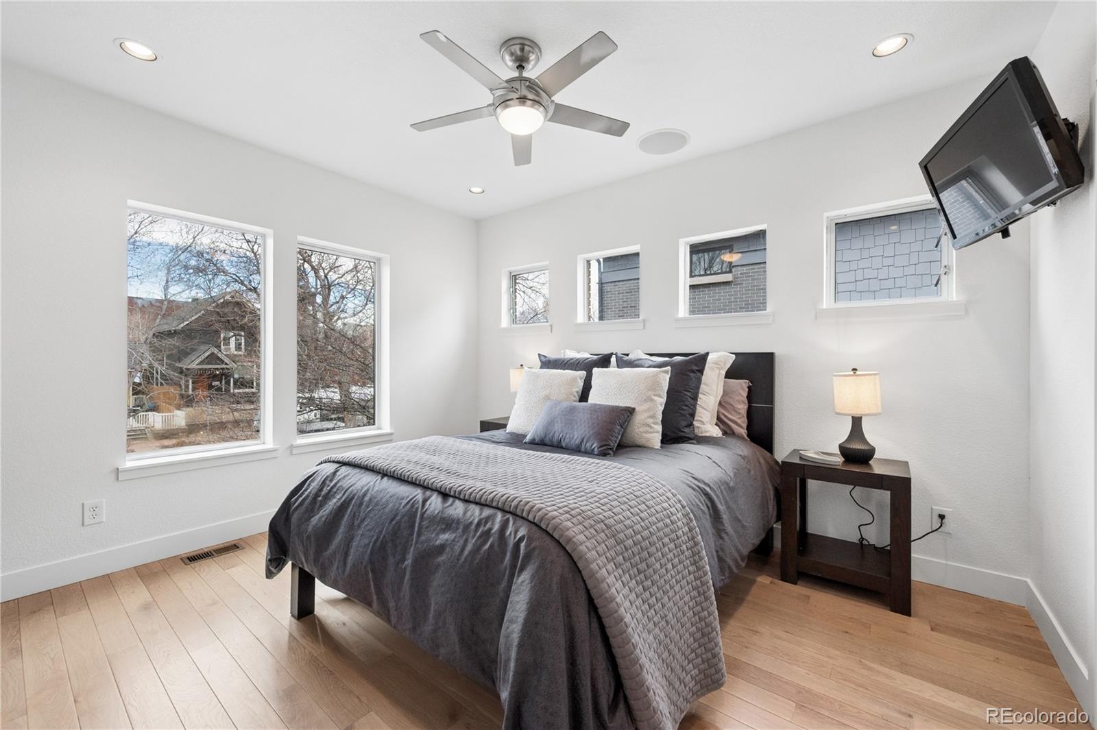 3118 Newton Street Denver, CO 80211 - Photo 13 of 29 a bedroom with a bed and a tv on table