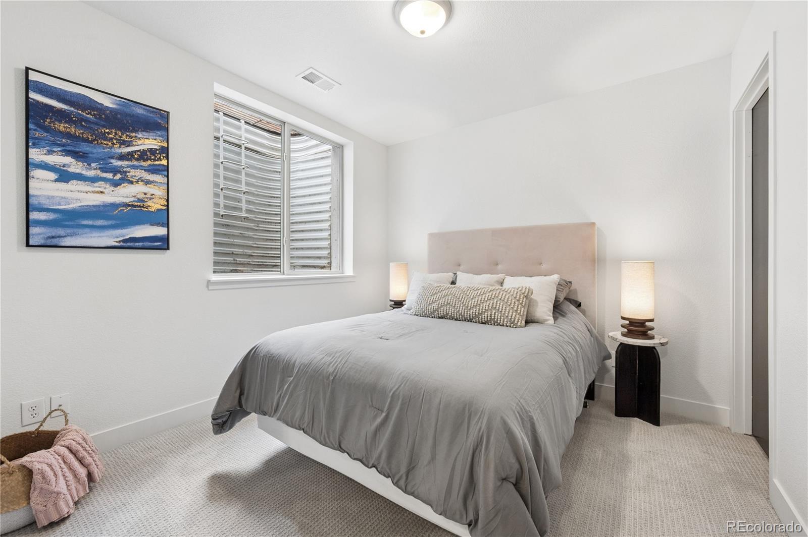 3118 Newton Street Denver, CO 80211 - Photo 18 of 29 a bedroom with a bed and a painting on the wall