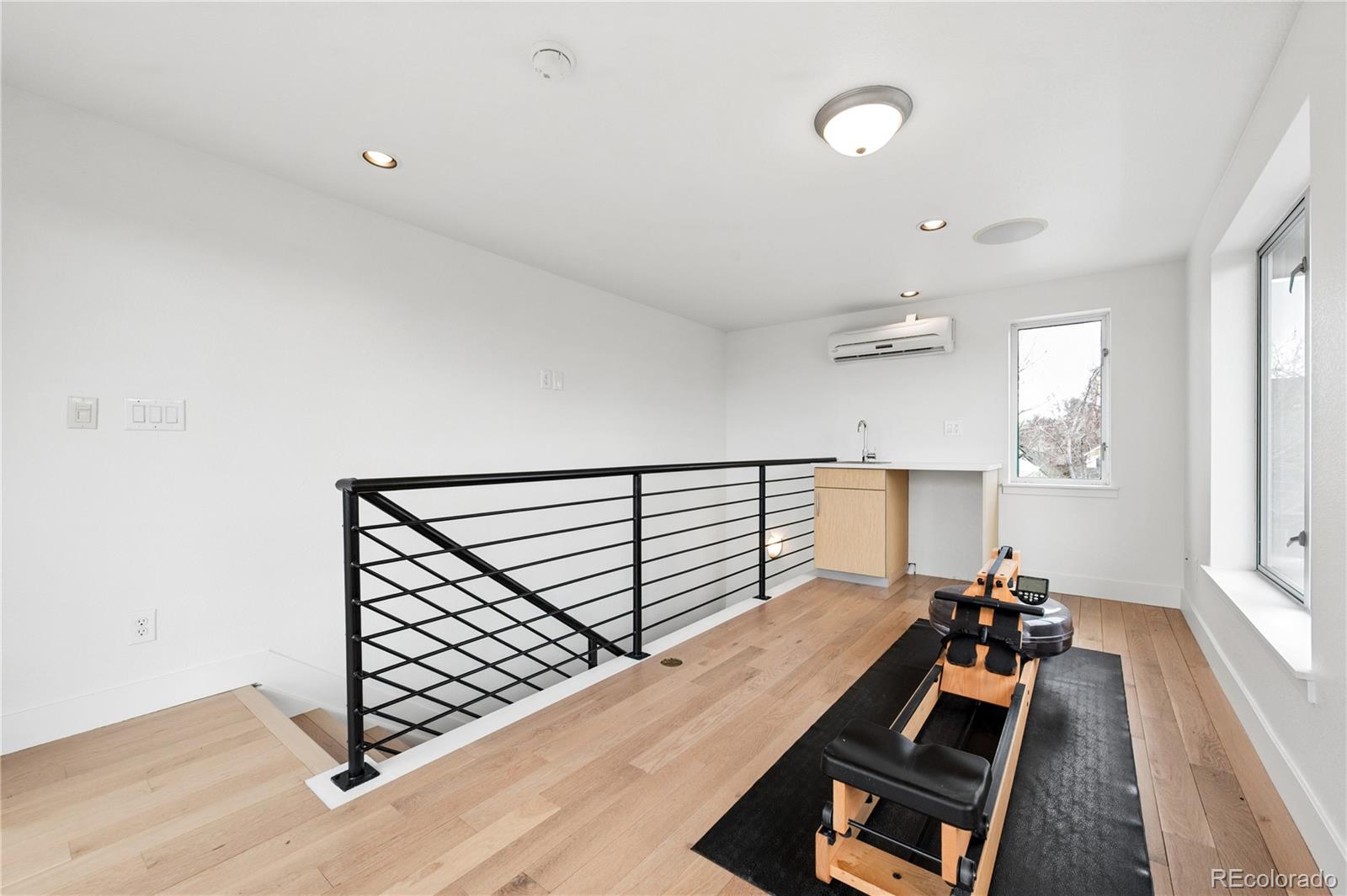 3118 Newton Street Denver, CO 80211 - Photo 19 of 29 an empty room with wooden floor and windows