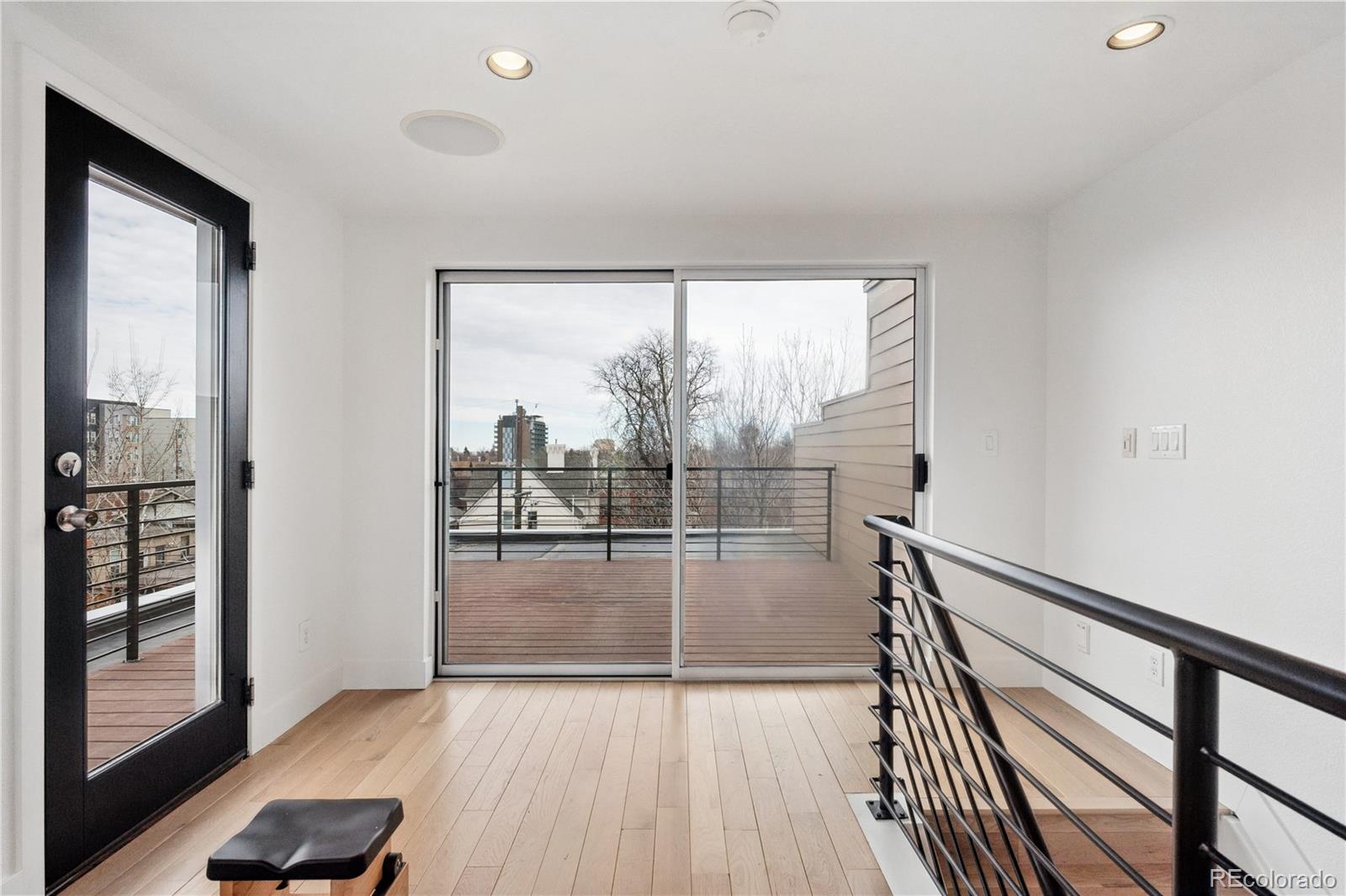 3118 Newton Street Denver, CO 80211 - Photo 20 of 29 a view of a room with wooden floor and windows