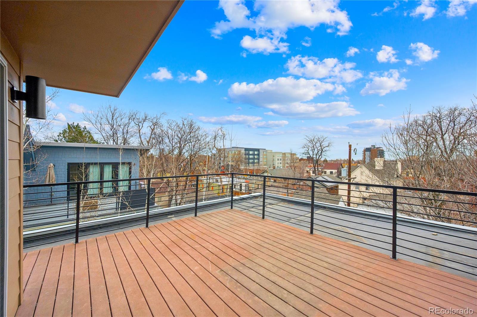 3118 Newton Street Denver, CO 80211 - Photo 21 of 29 a view of a roof deck with wooden floor and city view